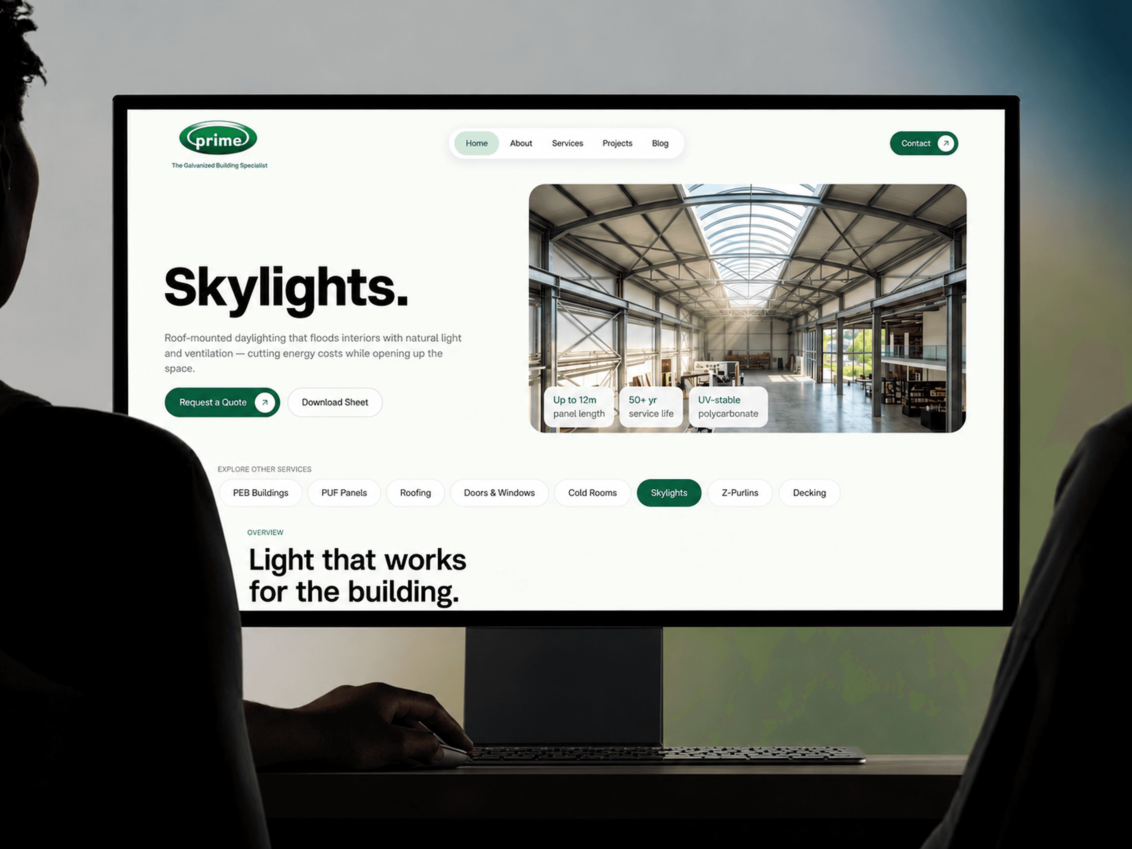 Someone at a desktop monitor showing the PrimeNMS Skylights product page, with the floating pill nav and service tabs