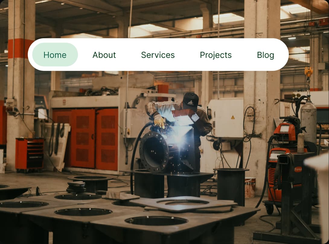 A welder at work on the fabrication floor, under the PrimeNMS site's floating pill navigation