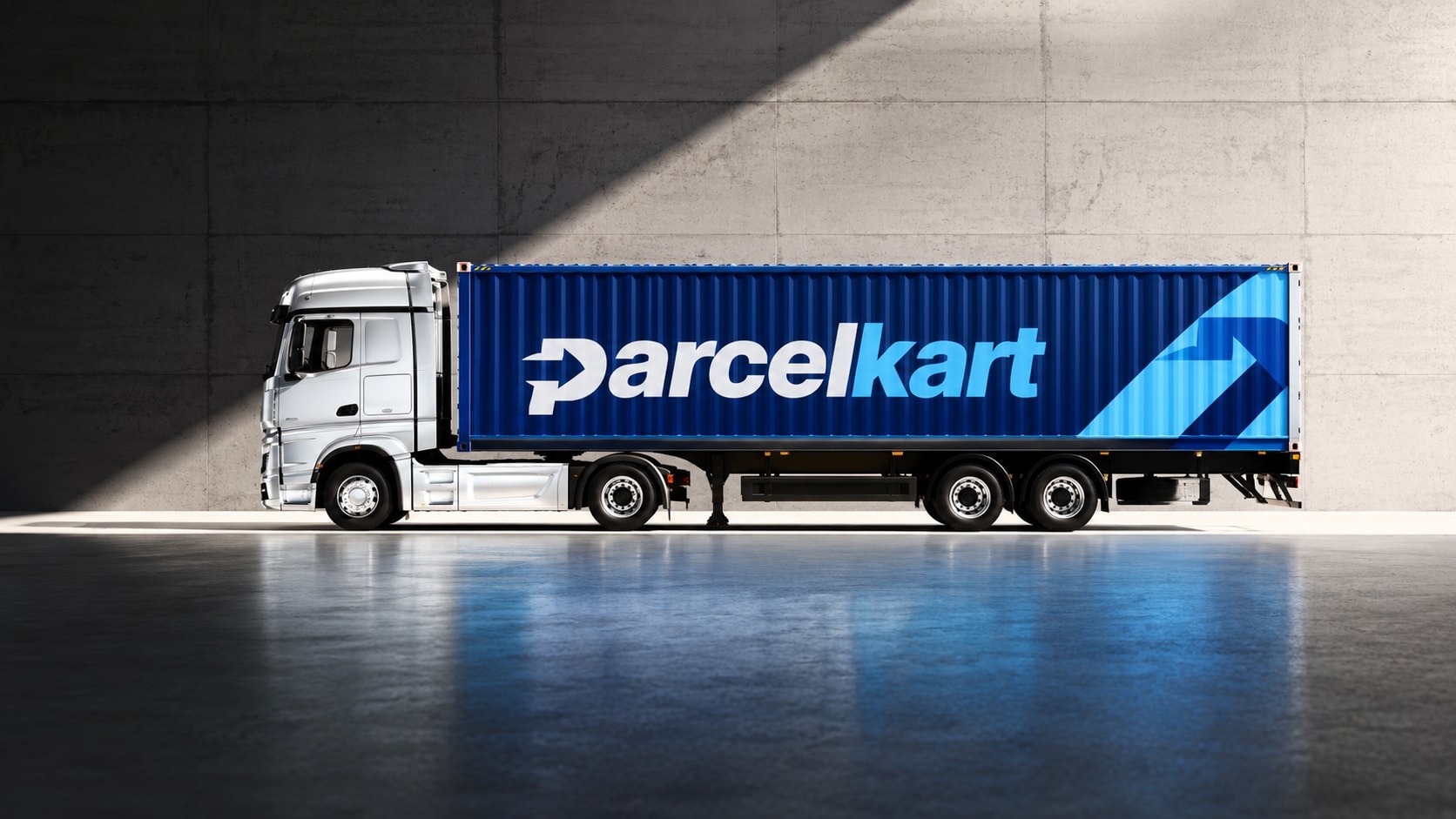 A lorry in a concrete hall, its blue container trailer branded ParcelKart